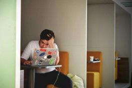 man wearing white top using MacBook